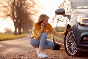 a woman waiting for vehicle recovery